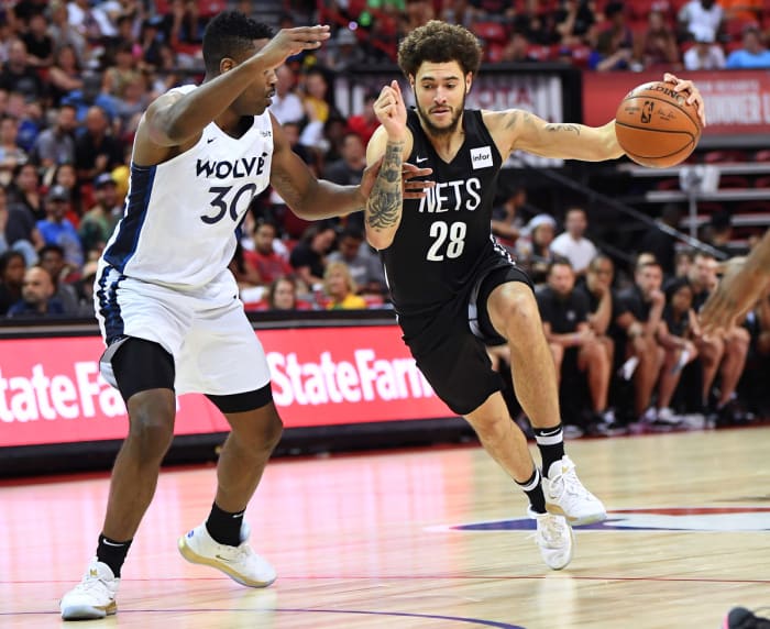 Brooklyn Nets guard Isaia Cordinier (28) dribbles against Minnesota Timberwolves forward Kelan Martin (30) during the second half of an NBA Summer League game against the Minnesota Timberwolves at Thomas & Mack Center.